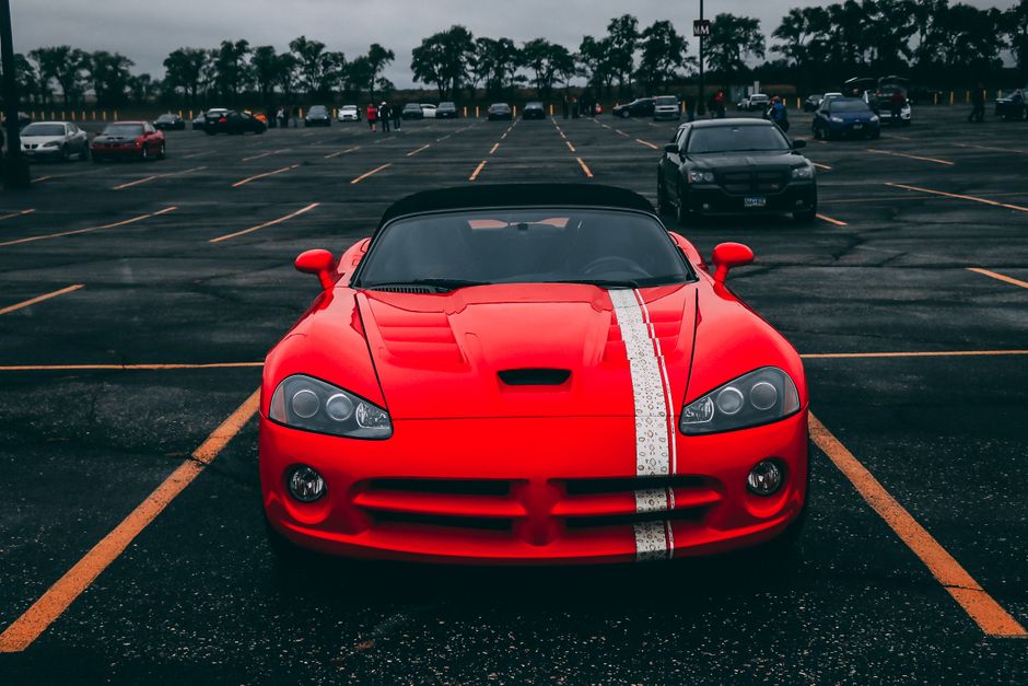 Vibrant red sports car parked in an empty lot